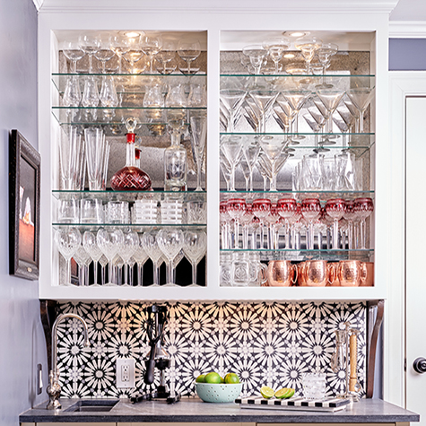 Wet Bar complete with ice maker, long vertical sink, antique mirror and stunning black and white graphic floral tile
