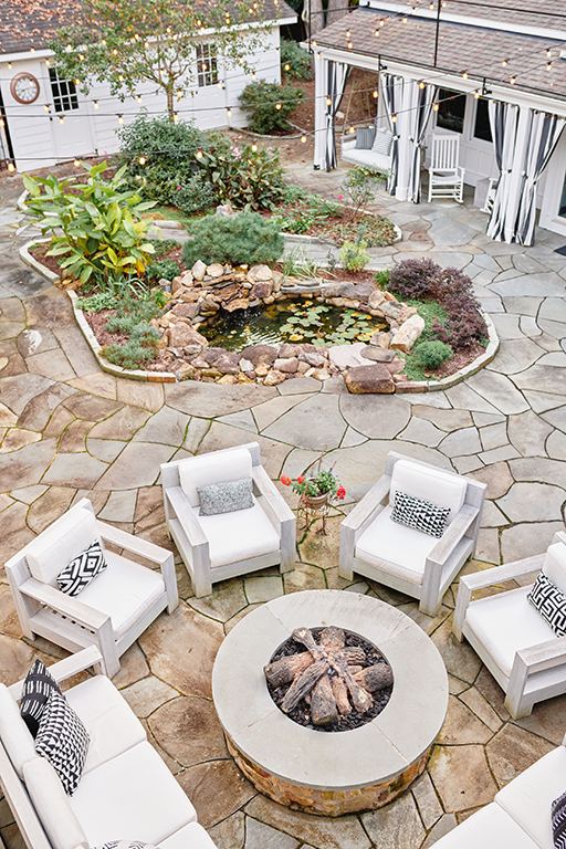 Flagstone courtyard with fire pit, garden beds and pond