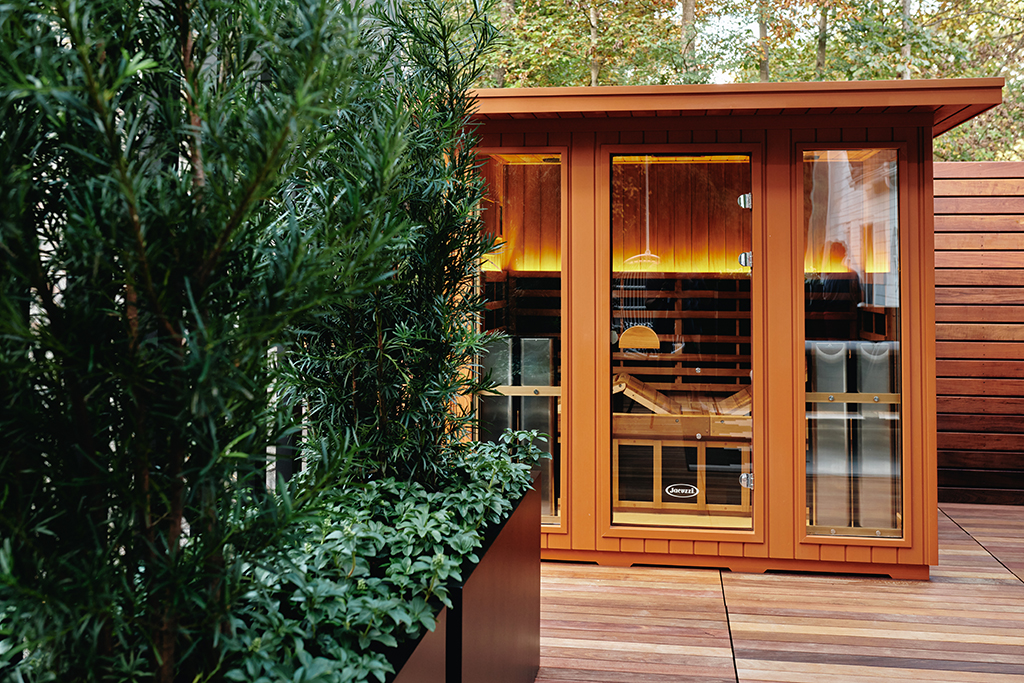 Clearlight outdoor infrared sauna, podocarpus and pachysandra planters
